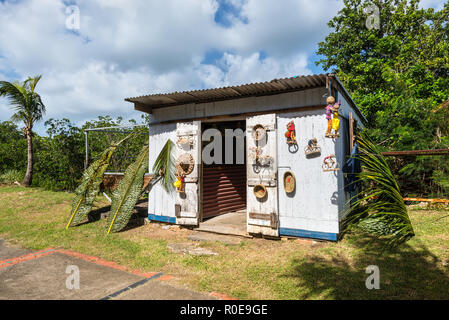 Le Gosier, Guadeloupe - December 20, 2016: Street vendor selling handmade souvenir to tourists at Le Gosier, Guadeloupe, an overseas region of France, Stock Photo