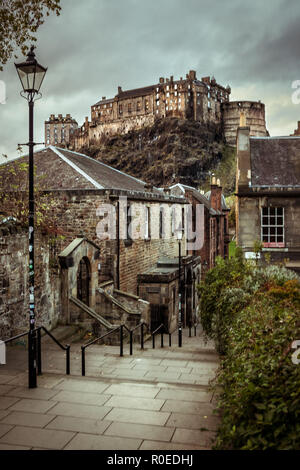 View of Edinburgh's Castle, in Scotland, from The Vennel steps in daylight, with grey moody sky. Travel. Cityscape. Stock Photo