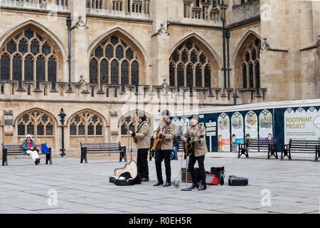 A Beatles tribute band busking in Bath Abbey courtyard, Bath, England, UK Stock Photo