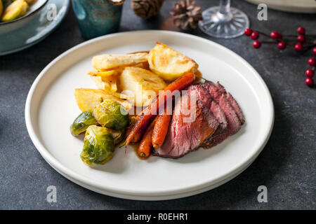 Roast dinner with beef, carrots, brussel sprouts and gravy Stock Photo