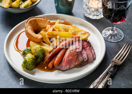 Roast dinner with beef, carrots, brussel sprouts and yorkshire pudding Stock Photo