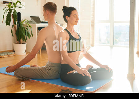 Spiritual couple meditating together at home Stock Photo