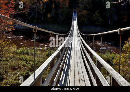 A horizontal image of a suspension bridge crossing the Hammond River at Upham in rural Saint John county New Brunswick, Canada. Stock Photo