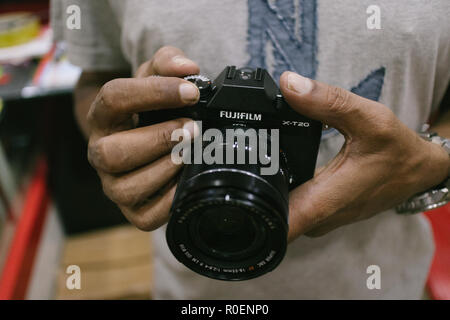 Indian customer checks brand new fujifilm X-t20 mirrorless camera at a camera store in Hyderabad,India Stock Photo