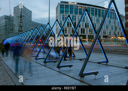 The Wave Triangle walkway construction by Vertigo; River of Light installation in Liverpool. The Wave' consists of forty, triangular, interactive, both glowing and sounding gates, 3,6 metres tall. People lined on both sides of the Mersey for the free spectacle to see Merseyside’s waterfront lit up with specially commissioned geometric light installations. Stock Photo