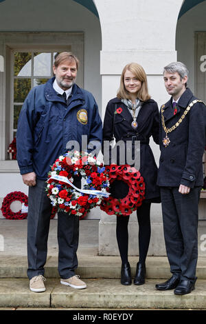 Woking, UK. 4th Nov 2018. L to R. Angelo Munsel, Superintendent Brookwood American Cemetery; Hannah Thompson, Woking Mayoress & Will Forster, Woking Mayor. The Brookwood Last Post has sounded unbroken since 1941 & is historically linked to Ypres, Belgium.  WyrdLight/ Alamy Live News. Stock Photo