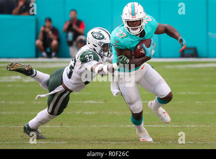 Miami Gardens, Florida, USA. 4th Nov, 2018. Miami Dolphins running back Kalen Ballage (27) advances the ball challenged by New York Jets strong safety Jamal Adams (33) during an NFL football game between the New York Jets and the Miami Dolphins at the Hard Rock Stadium in Miami Gardens, Florida. Credit: Mario Houben/ZUMA Wire/Alamy Live News Stock Photo