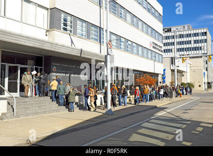 Cleveland, Ohio, USA.  4th Nov, 2018.  A diverse crowd of early voters wait in line to cast ballots for the 2018 US midterm elections.  The line at the Cuyahoga County Board of Elections goes down Superior Avenue and wraps around the building with an unprecedented number of early voters in the US making this one of the most momentous midterm elections in history.  Credit: Mark Kanning/Alamy Live News. Stock Photo