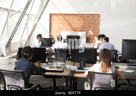 Office workers using computers working at modern big open space Stock Photo