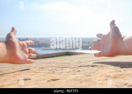 Arms spread out as welcome sign on beautiful Valletta landscape background Stock Photo