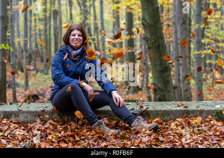 Young woman portrait with falling leaves, autumn Stock Photo