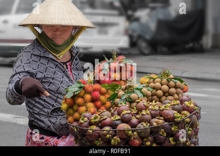 Woman selling fruit on street, Saigon, Vietnam. Stock Photo