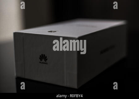 White box of a brand new P20 Lite mobile smartphone made by Chinese technology brand Huawei on a shiny black surface Stock Photo