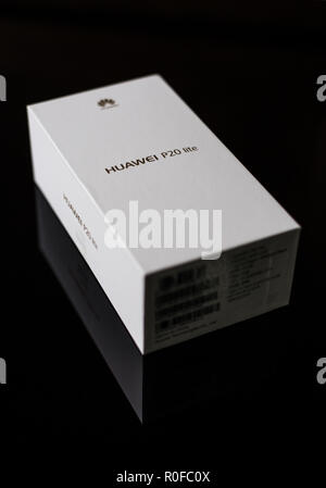 White box of a brand new P20 Lite mobile smartphone made by Chinese technology brand Huawei on a shiny black surface Stock Photo