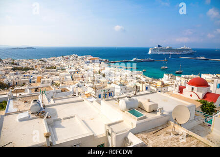 Panoramic view over Mykonos town with white architecture and cruise liner in port, Greece Stock Photo