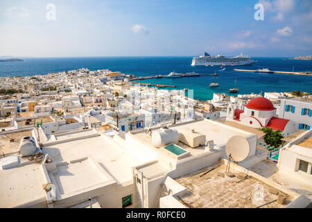 Panoramic view over Mykonos town with white architecture and cruise liner in port, Greece Stock Photo