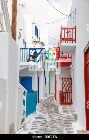 Traditional houses with blue doors and windows in the narrow streets of greek village in Mykonos, Greece Stock Photo