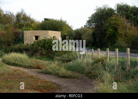 War-time pill box at roadside, Hayling Island, Hampshire, England Stock Photo