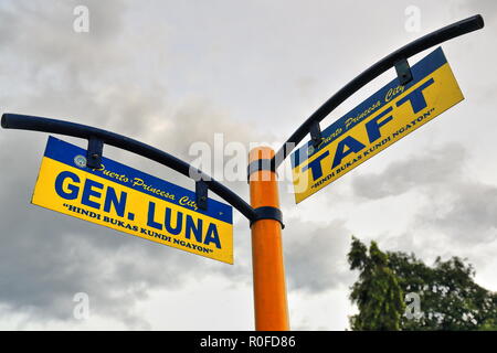 Street name signs blue and yellow on an orange colored sign pole placed at the Gen.Luna street-Taft street corner in the city's central area seen unde Stock Photo