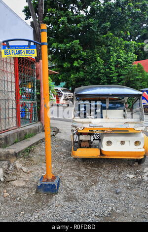 Colorist motor tricycles are a common means of public transportation in the country. Here one blue-white-orange waiting for passengers stopped at Seap Stock Photo