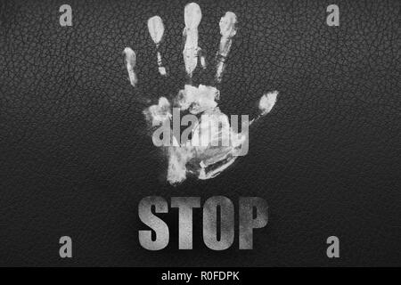 Illustration with the words stop. White hand on a black background. Stock Photo