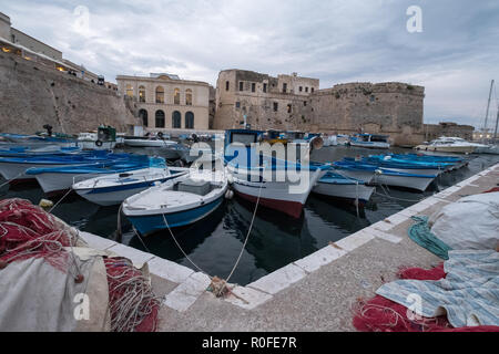 Colourful fishing boats in the harbour in the town of Gallipoli in the Salento Peninsula, Puglia, Southern Italy. Stock Photo