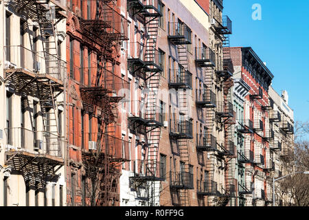 Repeating pattern of fire escapes on colorful old buildings along St. Marks Place in the East Village neighborhood of New York City Stock Photo