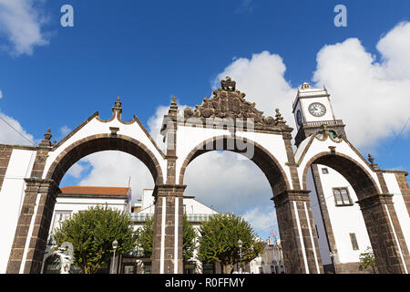 Portas da Cidade Gates and Saint Sabastian church with a clock tower in Ponta Delgada, Azores, Portugal. Azores capital city attractions under cloudy  Stock Photo