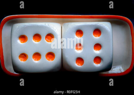 Selective focus on dices: Casino cube dice set. Number 6 gambling dices or red gaming dices on black background. Room for text. Game object Stock Photo
