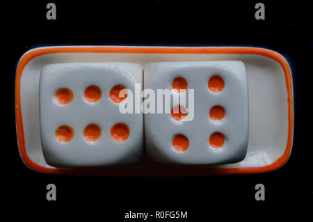 Selective focus on dices: Casino cube dice set. Number 6 gambling dices or red gaming dices on black background. Room for text. Game object or parlor  Stock Photo
