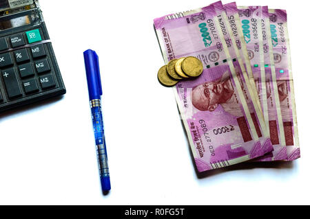 Focus on Gandhi. Indian paper currency rupees and coins stack, calculator and pen business growth symbol. Studio shot Isolated on white background Stock Photo