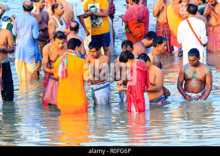 HARIDWAR, INDIA - JANUARY 14, 2016: Devotees taking holy dip at Har Ki Pauri on river Ganga on the first bath of Ardh Kumbh fair. People taking bath. Stock Photo