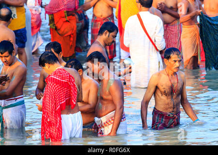 HARIDWAR, INDIA - JANUARY 14, 2016: Devotees taking holy dip at Har Ki Pauri on river Ganga on the first bath of Ardh Kumbh fair. People taking bath. Stock Photo