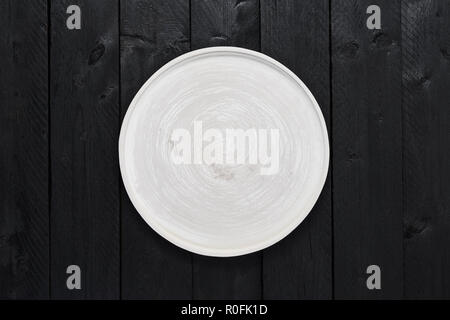 Top view of empty gray serving plate on black wooden table with copy space. Stock Photo