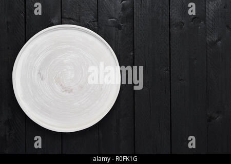 Top view of empty gray serving plate on black wooden table with copy space. Stock Photo