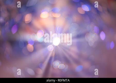 Abstract colorful xmas violet and pink glitter lights with shining flare. Christmas festive bokeh background. Defocused bokeh spots. Template for wint Stock Photo