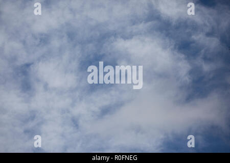Bright blue sky with white fluffy clouds Stock Photo