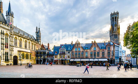 Historic buildings of the Town Hall and Basilica of the Holy Blood on Burg Square with the Belfry Tower in the medieval city of Brugge in Belgium Stock Photo