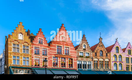 The colorful medieval houses with Step Gables lining the central Markt (Market Square) in the heart of Bruges, Belgium