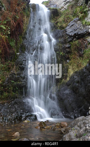 Water flows over four metre high Lightspout Waterfall, Long Mynd, Shropshire. This stream at the head of Carding Mill Valley, joins Cound Brook, a tributary to The River Severn Stock Photo