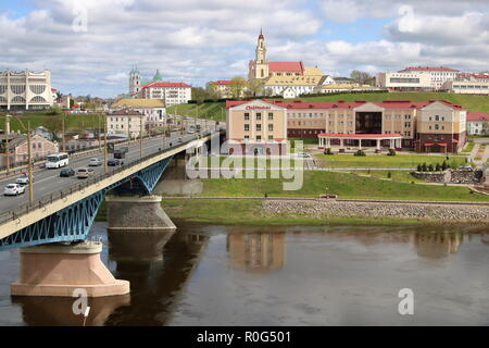 Cityscape of Grodno, Belarus, Polish city in past time, river Niemen, bridge, buildings, cloudy sky. Stock Photo