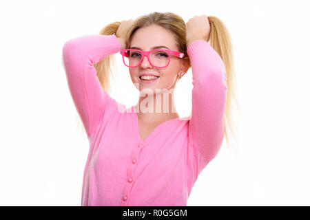 Studio shot of young happy teenage girl smiling while playing wi Stock Photo