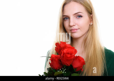 Close up of young beautiful teenage girl holding red roses ready Stock Photo