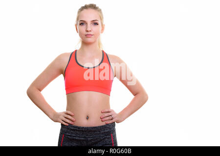 Studio shot of young beautiful teenage girl with hands on hips r Stock Photo