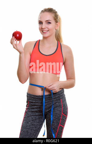 Young happy teenage girl smiling while holding red apple and mea Stock Photo