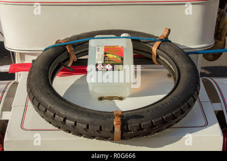 Classic car tyre seen on top of a a vintage car during an outdoor motoring event. Stock Photo