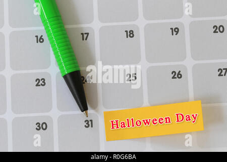 Green pen point to day 31 on calendar paper and have halloween text for the design in you festival concept. Stock Photo