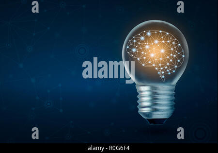 brain light bulb human brain glowing inside of light bulb on dark blue background Stock Photo