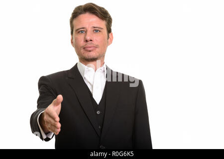 Caucasian businessman giving handshake and looking at camera Stock Photo