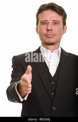 Caucasian businessman giving handshake while looking at camera Stock Photo